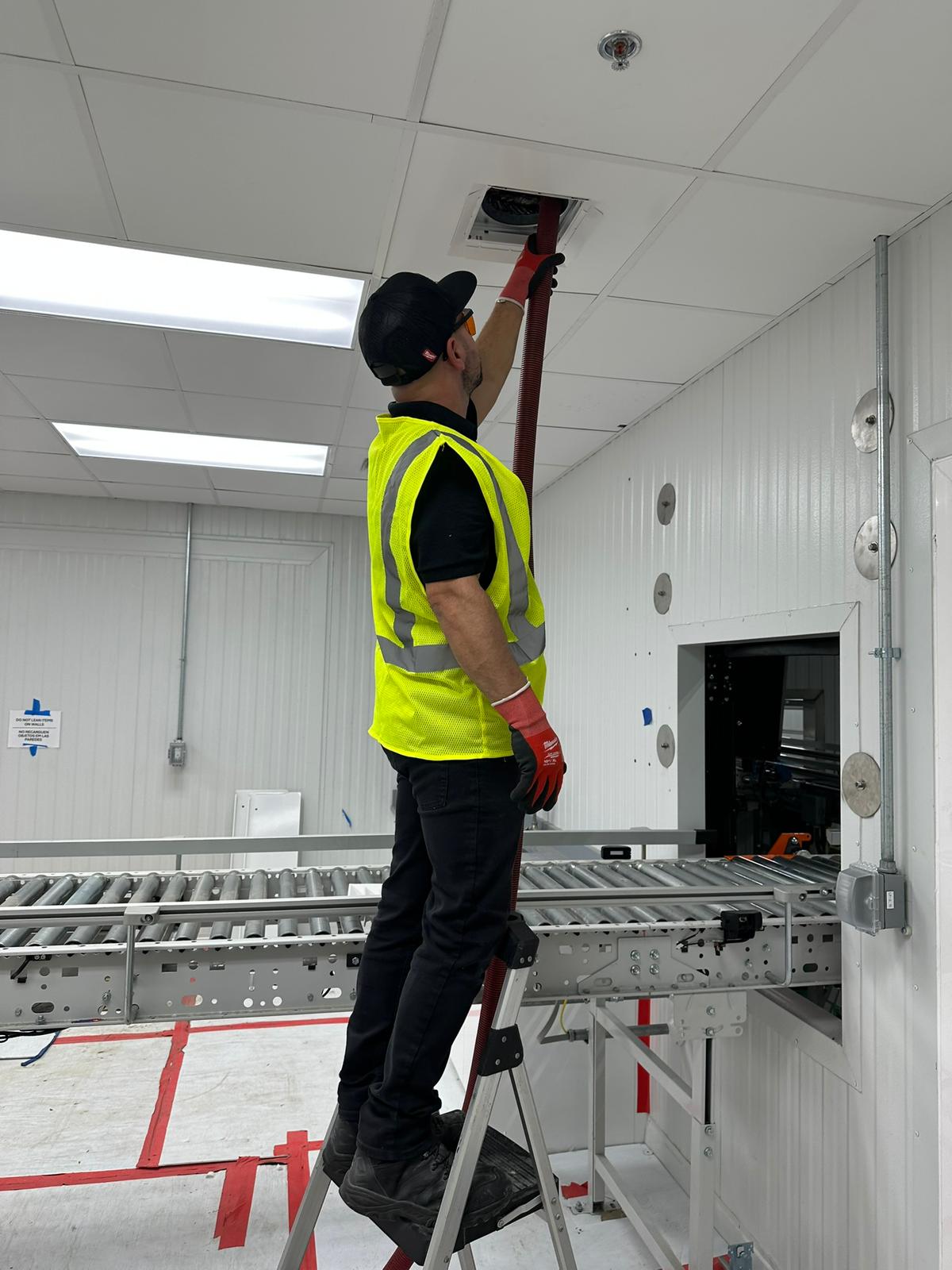 AAA All About Air technician performing air duct cleaning in commercial facility